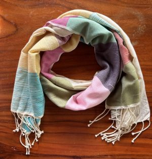 Colorful scarf on wooden surface